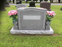 Gray granite upright headstone with pink flowers