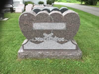 Ornate heart-top memorial stone with scrollwork
