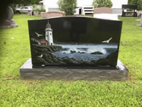 Black granite headstone with lighthouse etching